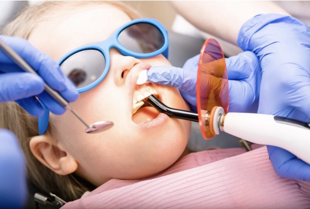 Child getting a white dental crown at babyprl
