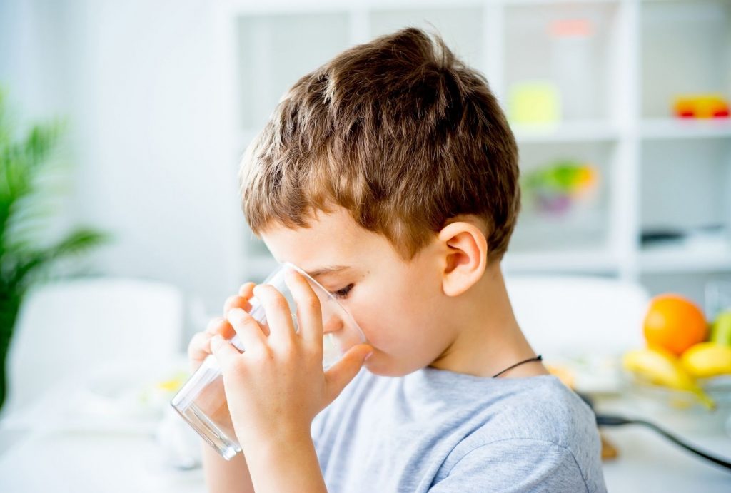 child drinking water instead of juice